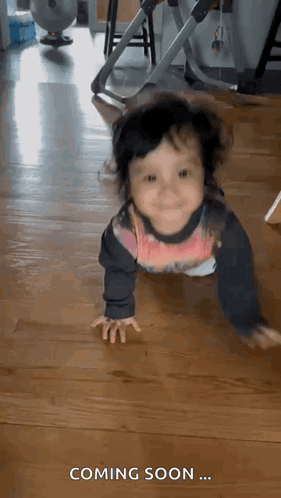 Baby Crawling on Wooden Floor Saying Coming Soon