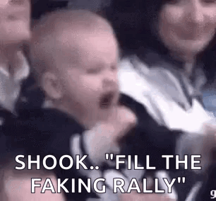 Baby Crying In Crowd Held By Woman GIF