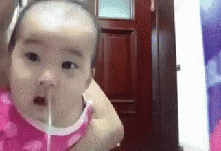 Baby Drinking Water From Straw in Woman's Arms