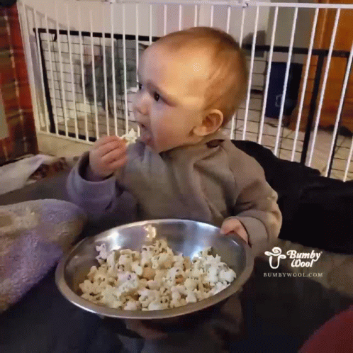 Baby Eating Popcorn From Bowl Saying Bumpy Woof