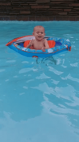 Baby Floating in Boat in Pool