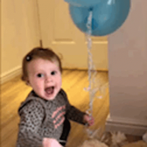 Baby Girl Holding Blue Balloon