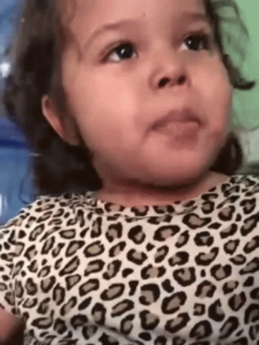Baby Girl in Leopard Print Shirt Making Funny Face