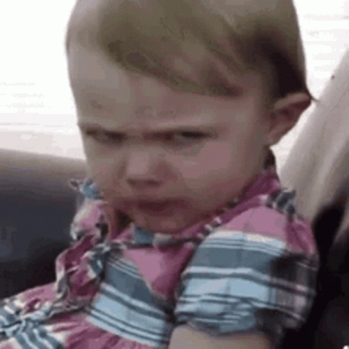 Baby Girl Making Funny Face in Car Seat