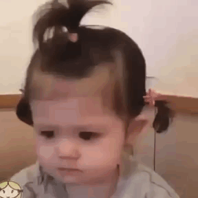 Baby Girl With Ponytail Making Sad Face GIF