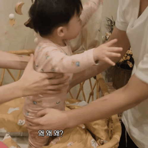 Baby Held by Woman with Korean Writing