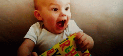 Baby Holding Birthday Wrapping Paper Mouth Open