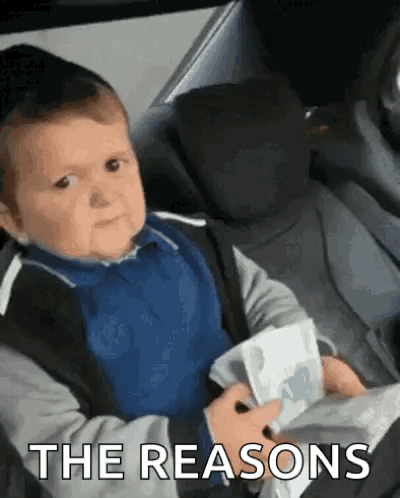Baby in Car Seat Holding Paper Making Face