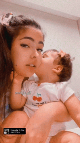 Baby in Cherry Onesie Kissing Woman