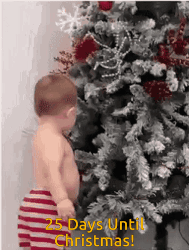 Baby in Front of Christmas Tree Saying 25 Days Until Christmas