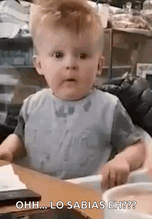 Baby in High Chair Making Funny Face
