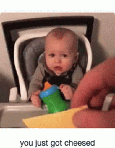 Baby in High Chair with Bottle and Cheese