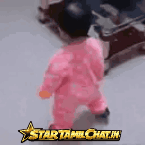 Baby In Pink Outfit Walking In Front Of Startamilchat.in GIF