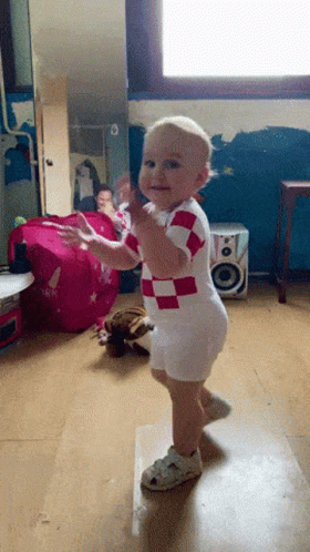 Baby in Red and White Checkered Outfit Dancing