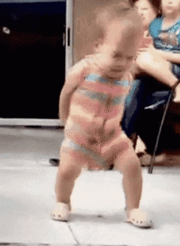 Baby in Striped Outfit Dancing