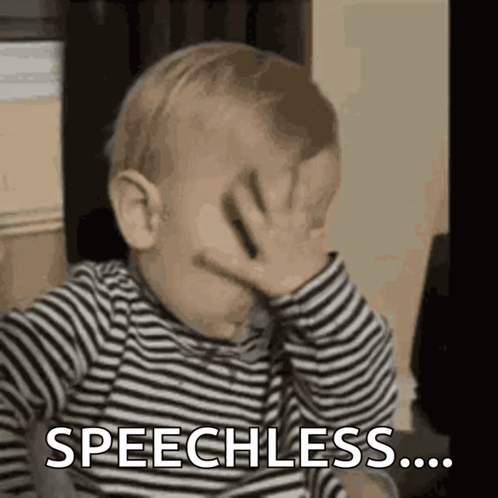 Baby in Striped Shirt Covering Face Speechless