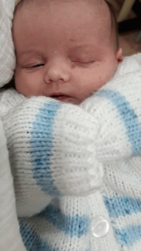 Baby in White and Blue Sweater
