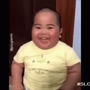 Baby In Yellow Shirt Smiling And Laughing GIF