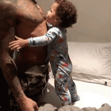 Baby Kissing Man's Chest on Bed