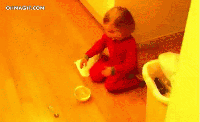 Baby Kneeling Near Trash Can and Food Bowl