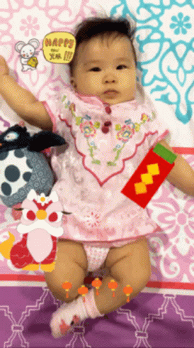 Baby Laying on Bed With Happy Sign