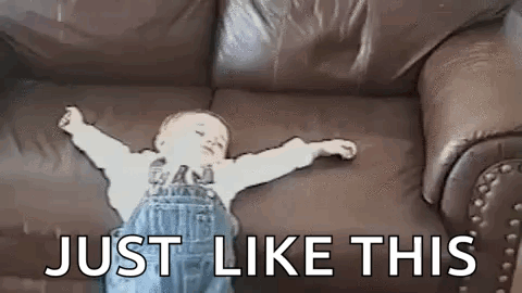 Baby Laying on Couch Arms Outstretched
