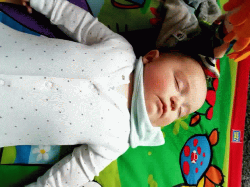 Baby Laying on Play Mat With Fisher Price Sticker