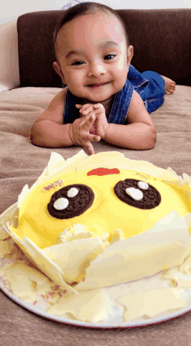 Baby Lying Next To Sun-Shaped Cake GIF