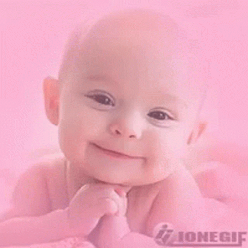 Baby Lying on Pink Blanket Smiling