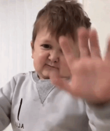Baby Making Funny Face Covering Ears GIF