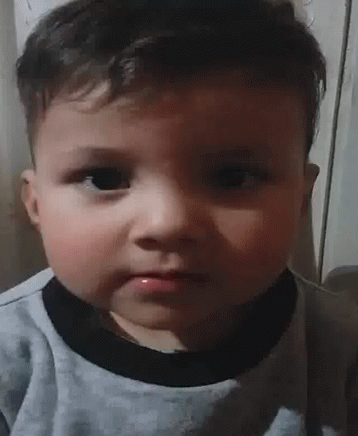 Baby Making Funny Face In Gray Shirt GIF
