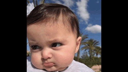 Baby Making Funny Face With Blue Sky GIF