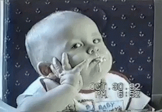 Baby Making Peace Sign While Eating