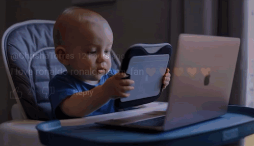 Baby Playing with Tablet and Laptop in High Chair