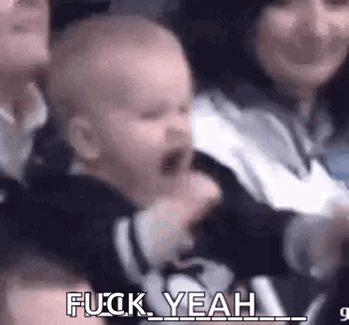 Baby Screaming In Crowd Held By Woman GIF