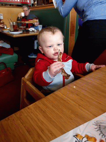 Baby Sitting at Table With Food
