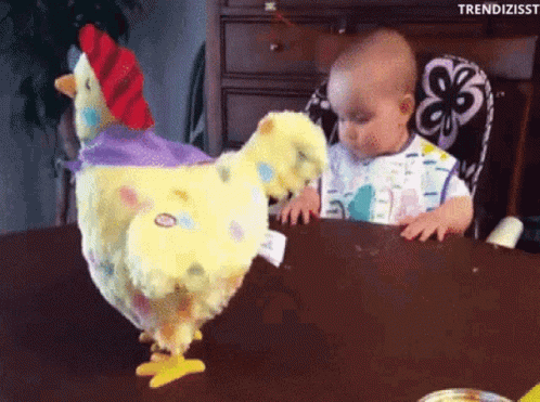Baby Sitting at Table With Stuffed Chicken