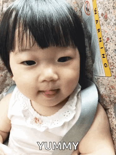 Baby Sitting in Car Seat with Warning Label