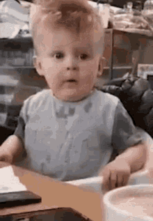 Baby Sitting in High Chair Making Funny Face