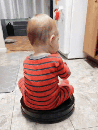 Baby Sitting on Vacuum Cleaner