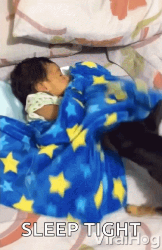 Baby Sleeping on Bed with Blue Star Blanket