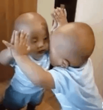 Baby Touching Face in Mirror