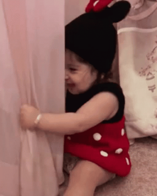 Baby Trying To Hide With Curtain GIF