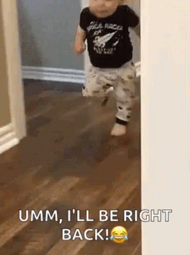 Baby Walking on Wooden Floor in Black Shirt
