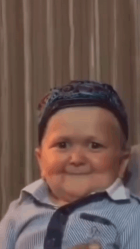 Baby Wearing Hat And Striped Shirt Smiling GIF