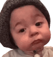 Baby Wearing Knitted Hat Making Funny Face