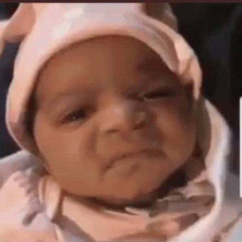 Baby Wearing Pink Hat Making Funny Face