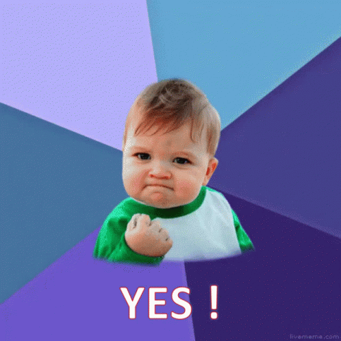 Baby With Fist In The Air Saying Yes GIF