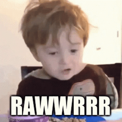 Baby With Plate of Food Saying Rawwrrr