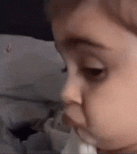 Baby With Tissue In Mouth GIF